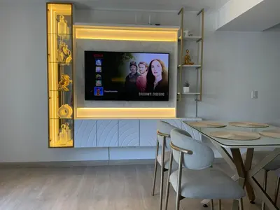 a living room with a television on a wall at Modern apartment in Larco 791 in Lima