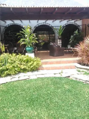 an outdoor patio with plants and a lawn at Nice country house with a swimming pool and large garden in Cieneguilla