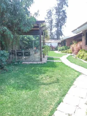 a garden with a gazebo in a yard at Nice country house with a swimming pool and large garden in Cieneguilla