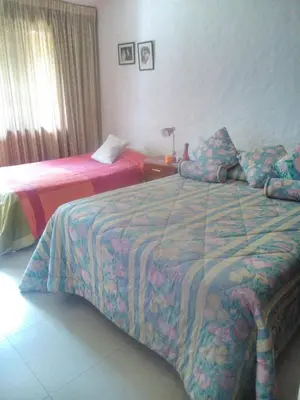 a hotel room with two beds in a bedroom at Nice country house with a swimming pool and large garden in Cieneguilla