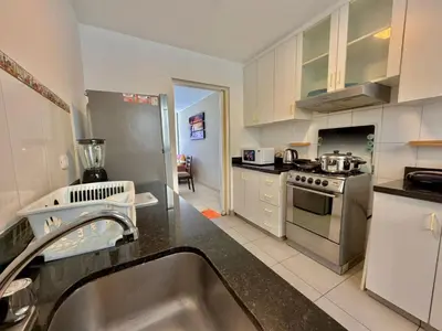 a kitchen with a sink and a stove top oven at Casa de Liz in Lima