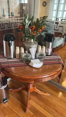 a wooden table with vases and flowers on it at Xima Cusco Kenamari in Cusco
