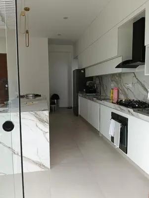 a large white kitchen with marble counter tops at House 3M in Condominium Fundo Pradera, Chocaya - Lima - Perú in Asia