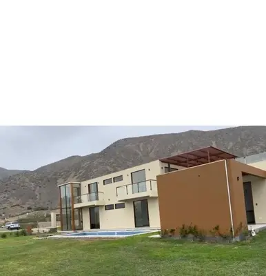 a large building with a mountain in the background at House 3M in Condominium Fundo Pradera, Chocaya - Lima - Perú in Asia