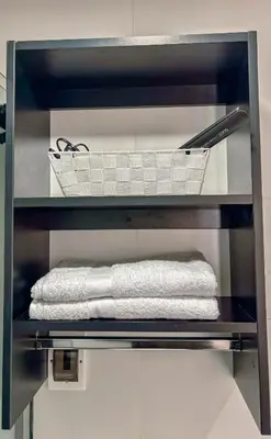 a shelf with a basket and towels on it at Departamento Illapa in Cusco