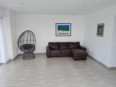 a living room with a couch and a chair at Duplex - Playa Embajadores in Quebrada Seca