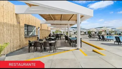a pavilion with tables and chairs on a patio at Vacaciones sin Estres, ambiente relajado y familiar in San Antonio