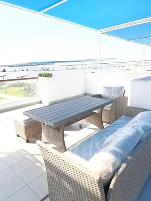 a picnic table and chairs on a balcony at Vacaciones sin Estres, ambiente relajado y familiar in San Antonio