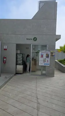 a store with a woman standing outside of it at Departamento exclusivo en San Bartolo in San Bartolo