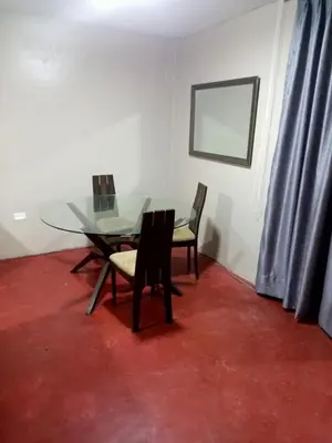 a dining room with a glass table and chairs at Departamento 2 dormitorios 4B in Lima