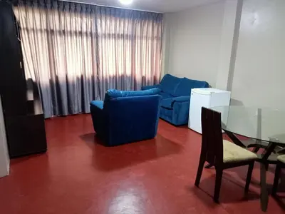 a living room with a blue couch and a glass table at Departamento 2 dormitorios 4B in Lima