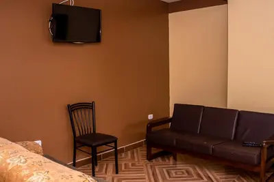 a living room with a couch and a chair at Departamentos Santa Ana Barrio Tradicional in Cusco