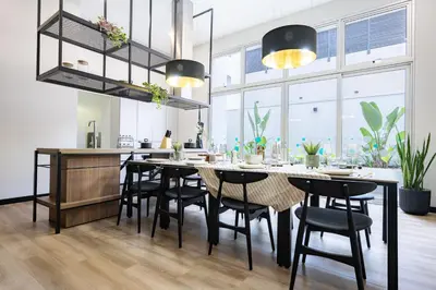 a kitchen and dining room with a large table and chairs at All San Isidro Apartments by Vibrant in Lima