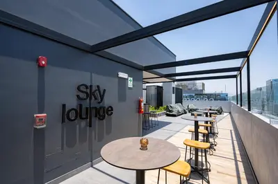 a rooftop patio with tables and chairs on a building at All San Isidro Apartments by Vibrant in Lima