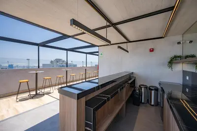 a bar with a view of a balcony with bar stools at All San Isidro Apartments by Vibrant in Lima