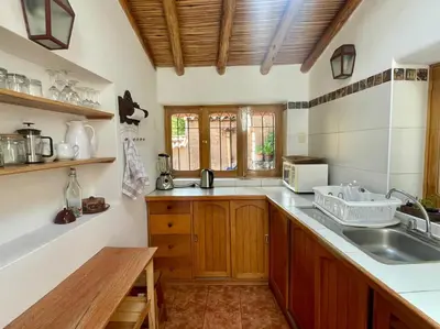 a kitchen with a sink and a counter top at Kusi Qente in Cusco