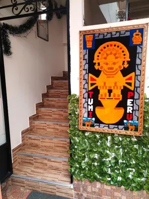 a mural on the side of a building with a staircase at Encanto del Cusco in Cusco