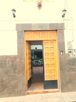 a wooden door in a building with at Encanto del Cusco in Cusco