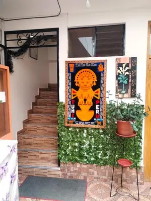 a rug on the side of a house with a staircase at Encanto del Cusco in Cusco