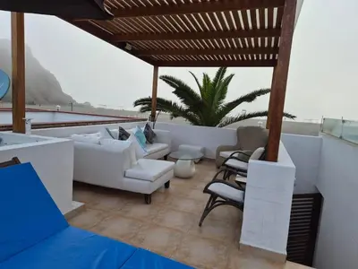 a living room with couches and chairs on a roof at Front Beach House nearby Playa Asia in Lima, Peru! in Cerro Azul