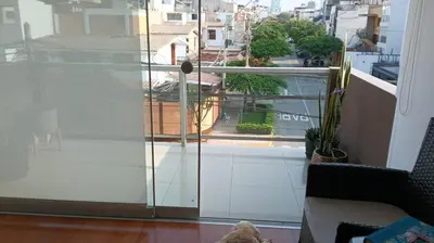 a room with a window with a view of a city at Habitación in Lima