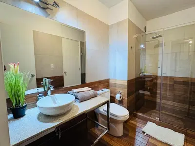 a bathroom with a sink and a toilet and a shower at M15 - Two Bedroom Apartment in front of the US Embassy in Lima
