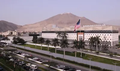 a large white building with an american flag in front at M15 - Two Bedroom Apartment in front of the US Embassy in Lima