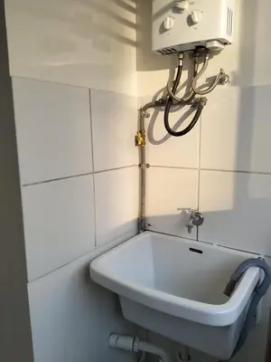 a bathroom with a sink and a light on the wall at Welcome to this apartment Pet friendly in Lima