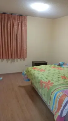 a bedroom with a bed with a colorful comforter at Welcome to this apartment Pet friendly in Lima