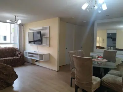 a living room with a table and chairs and a television at Welcome to this apartment Pet friendly in Lima