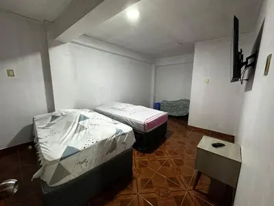 a small room with two beds in it at Quinta Maravillas in Ayacucho
