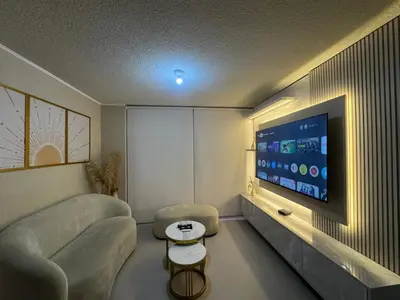 a living room with a couch and a flat screen tv at Flat 1BR San Miguel cerca a Malecón con balcón in Lima