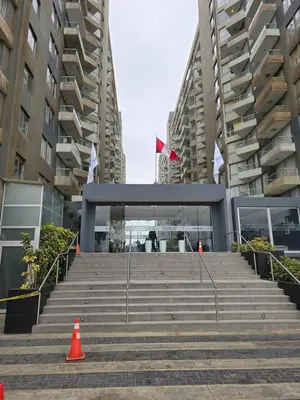 a set of stairs in a city with tall buildings at Flat 1BR San Miguel cerca a Malecón con balcón in Lima