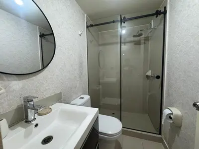 a bathroom with a shower and a sink and a toilet at Flat 1BR San Miguel cerca a Malecón con balcón in Lima