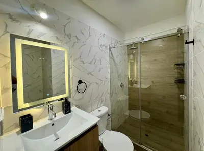 a bathroom with a sink and a shower and a toilet at Departamento 2BR Santa Beatriz cerca al Circuito Mágico del Agua Céntrico in Lima