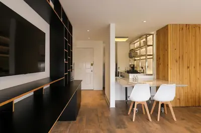 a kitchen with a table and two white chairs at Moderno apartamento en San Isidro in Lima