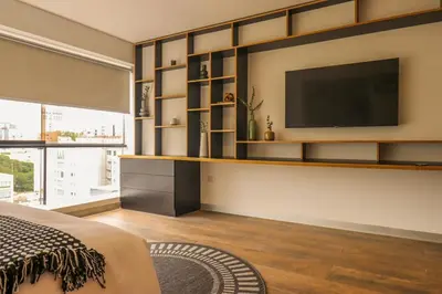 a bedroom with a flat screen tv on a wall at Moderno apartamento en San Isidro in Lima