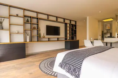 a bedroom with a large white bed and a tv at Moderno apartamento en San Isidro in Lima
