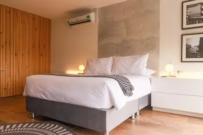 a bedroom with a white bed and a white dresser at Moderno apartamento en San Isidro in Lima