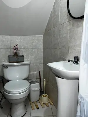 a bathroom with a toilet and a sink at AndeanNook-Cusco in Cusco
