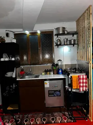 a small kitchen with a sink and a stove at AndeanNook-Cusco in Cusco