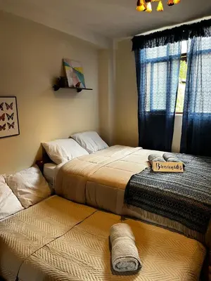 two beds sitting next to each other in a bedroom at AndeanNook-Cusco in Cusco
