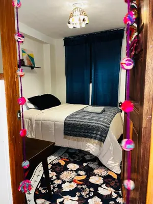 a bedroom with a bed and a rug at AndeanNook-Cusco in Cusco