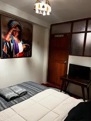 a bedroom with a bed and a painting on the wall at AndeanNook-Cusco in Cusco