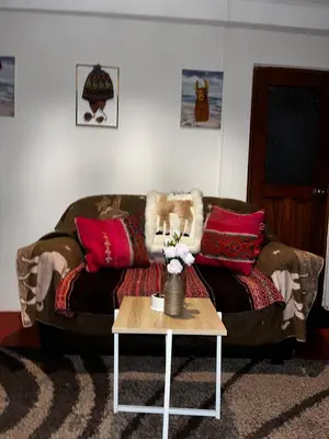 a living room with a couch and a table at AndeanNook-Cusco in Cusco