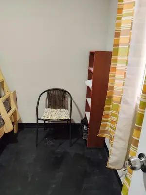 a chair sitting in a room next to a shelf at Sweet Rustic Home in Salinas