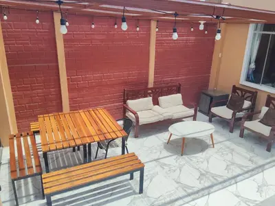 a patio with benches and chairs and a brick wall at Sweet Rustic Home in Salinas