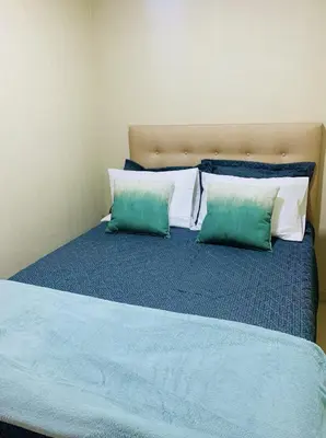 a bed with two green and white pillows on it at Encantadora casa en Menorca - Ica in Ica