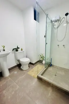 a bathroom with a toilet and a glass shower at Encantadora casa en Menorca - Ica in Ica