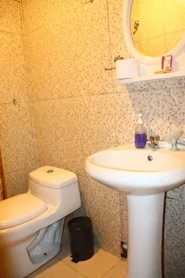 a bathroom with a sink and a toilet and a mirror at Machupicchu Royal Mountain in Machu Picchu